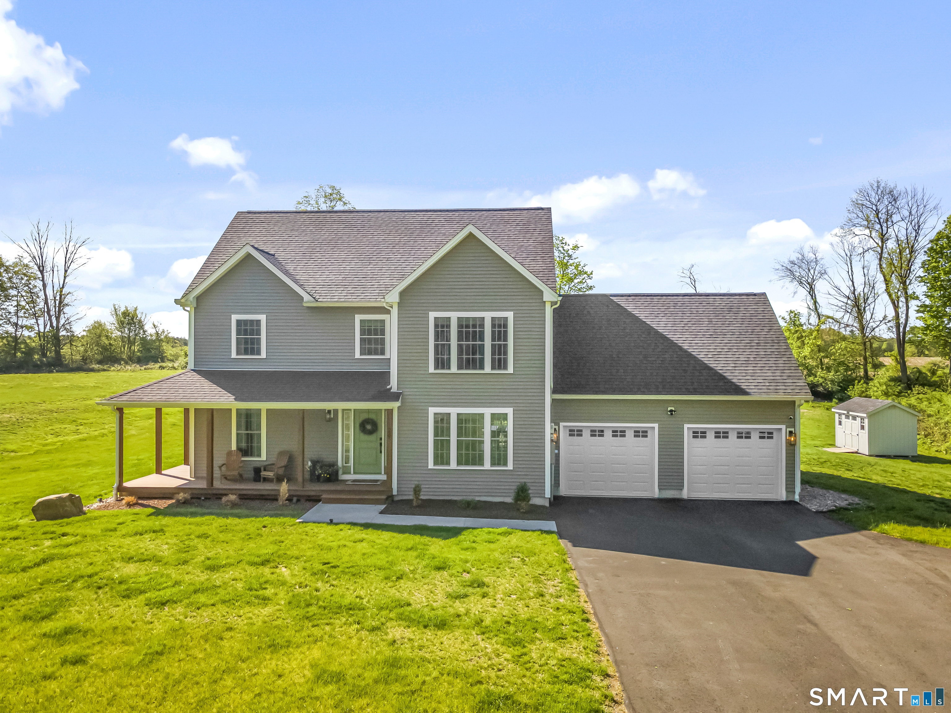29 Beecher Road Brooklyn, CT 06234 - Photo 1 of 40 a front view of a house with a yard and garage