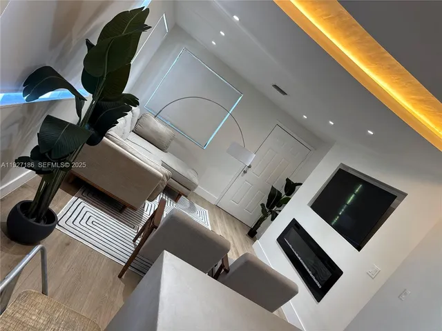 a view of living room with furniture and flat screen tv