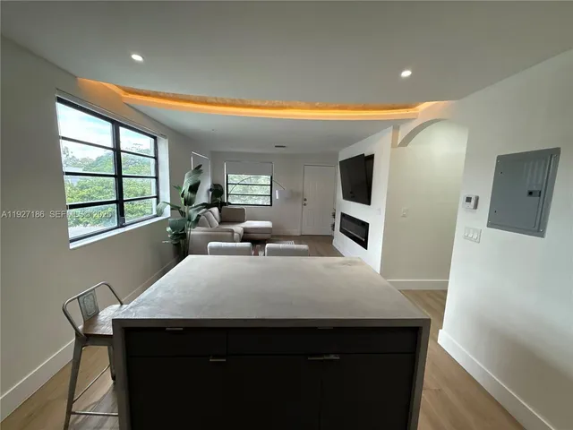 a kitchen with a table chairs sink and microwave