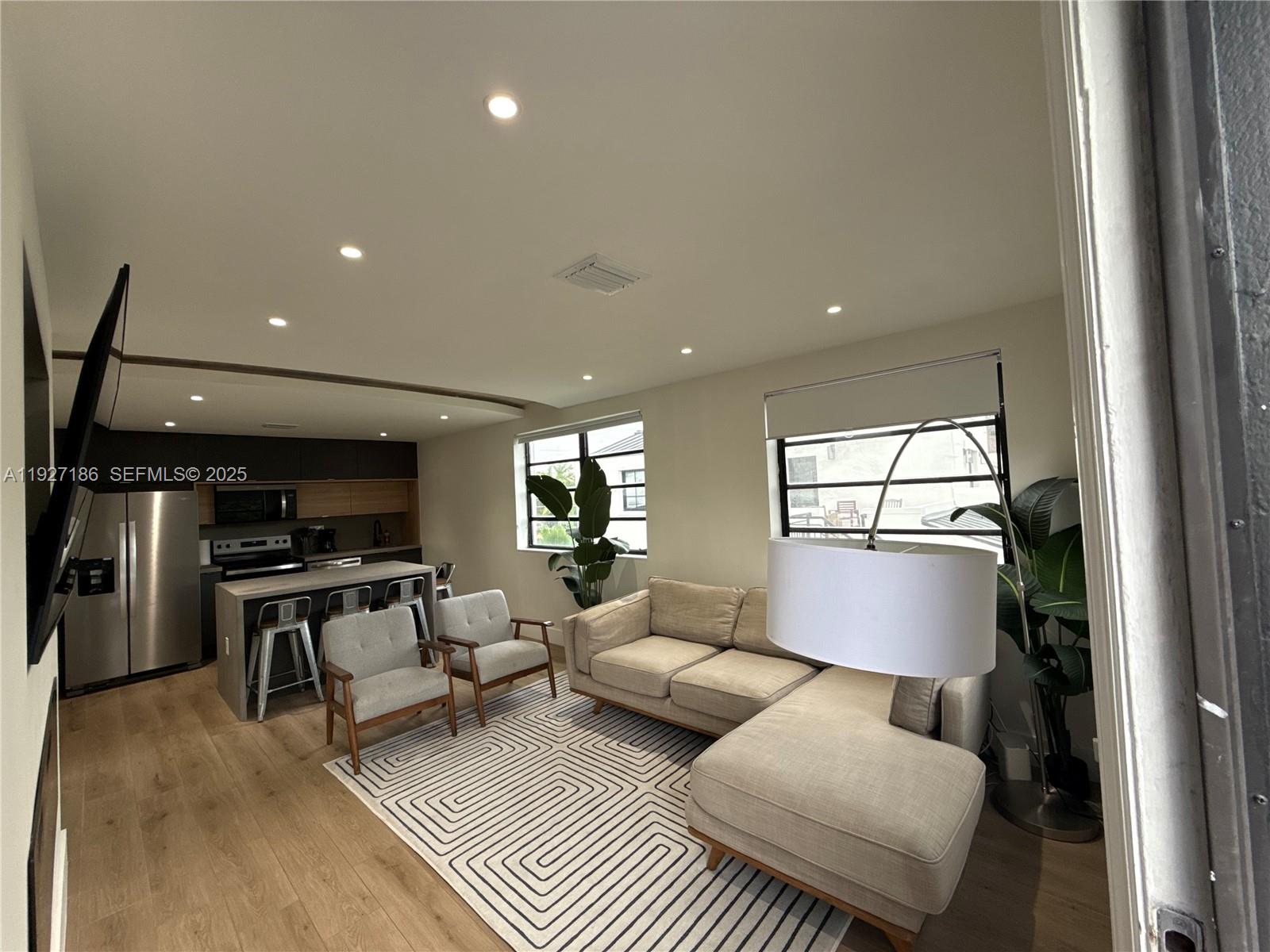 1716 Southwest 11th Street, Unit 4 Miami, FL 33135 - Photo 4 of 12 a living room with furniture and a window