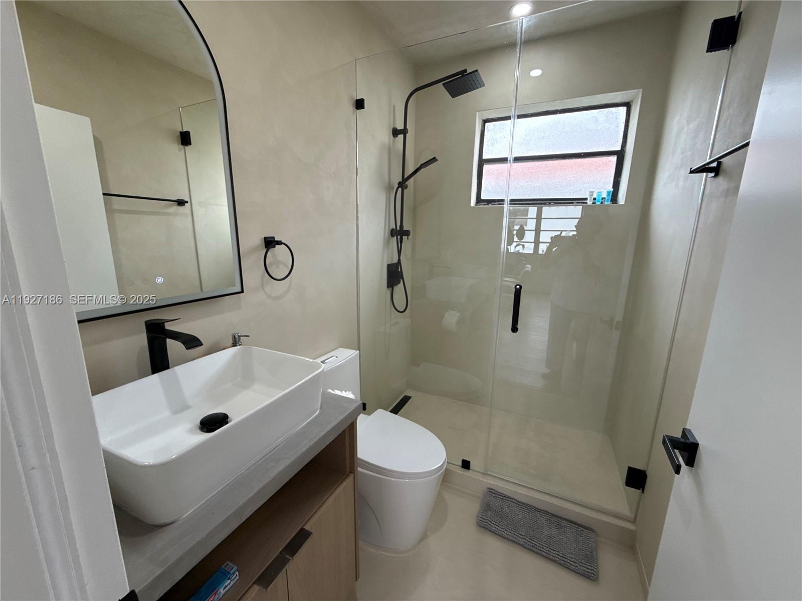 1716 Southwest 11th Street, Unit 4 Miami, FL 33135 - Photo 8 of 12 a bathroom with a sink toilet and shower