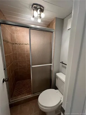 a bathroom with a toilet and a shower