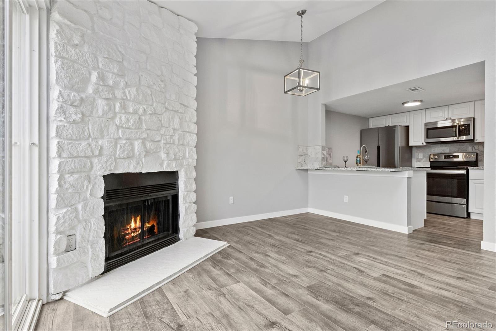 3100 South Federal Boulevard, Unit 331 Denver, CO 80236 - Photo 17 of 29 a view of a kitchen with furniture and a fireplace