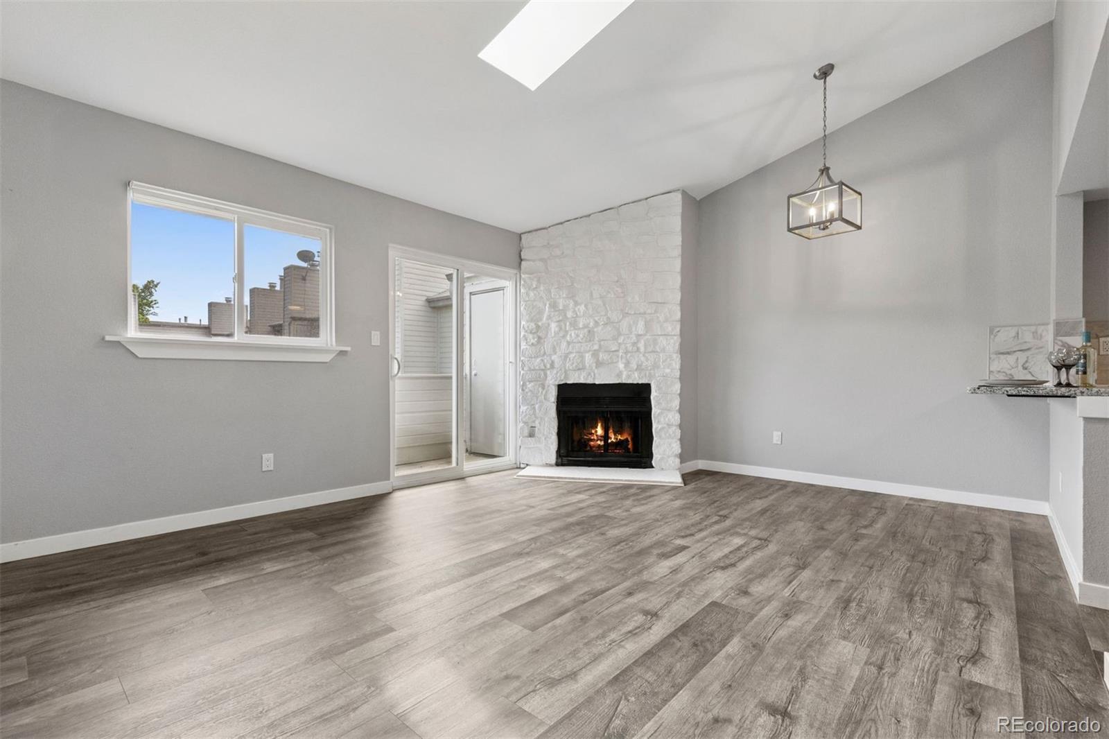 3100 South Federal Boulevard, Unit 331 Denver, CO 80236 - Photo 18 of 29 a view of empty room with wooden floor and fireplace