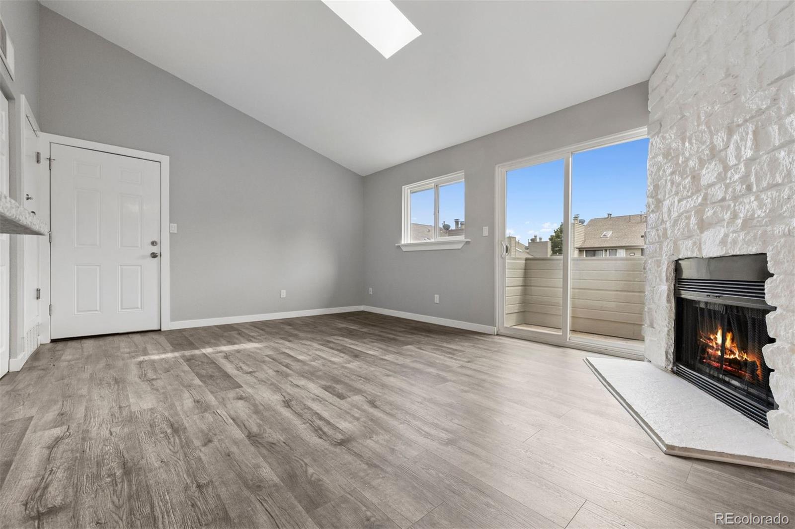 3100 South Federal Boulevard, Unit 331 Denver, CO 80236 - Photo 19 of 29 a view of empty room with a fireplace and wooden floor