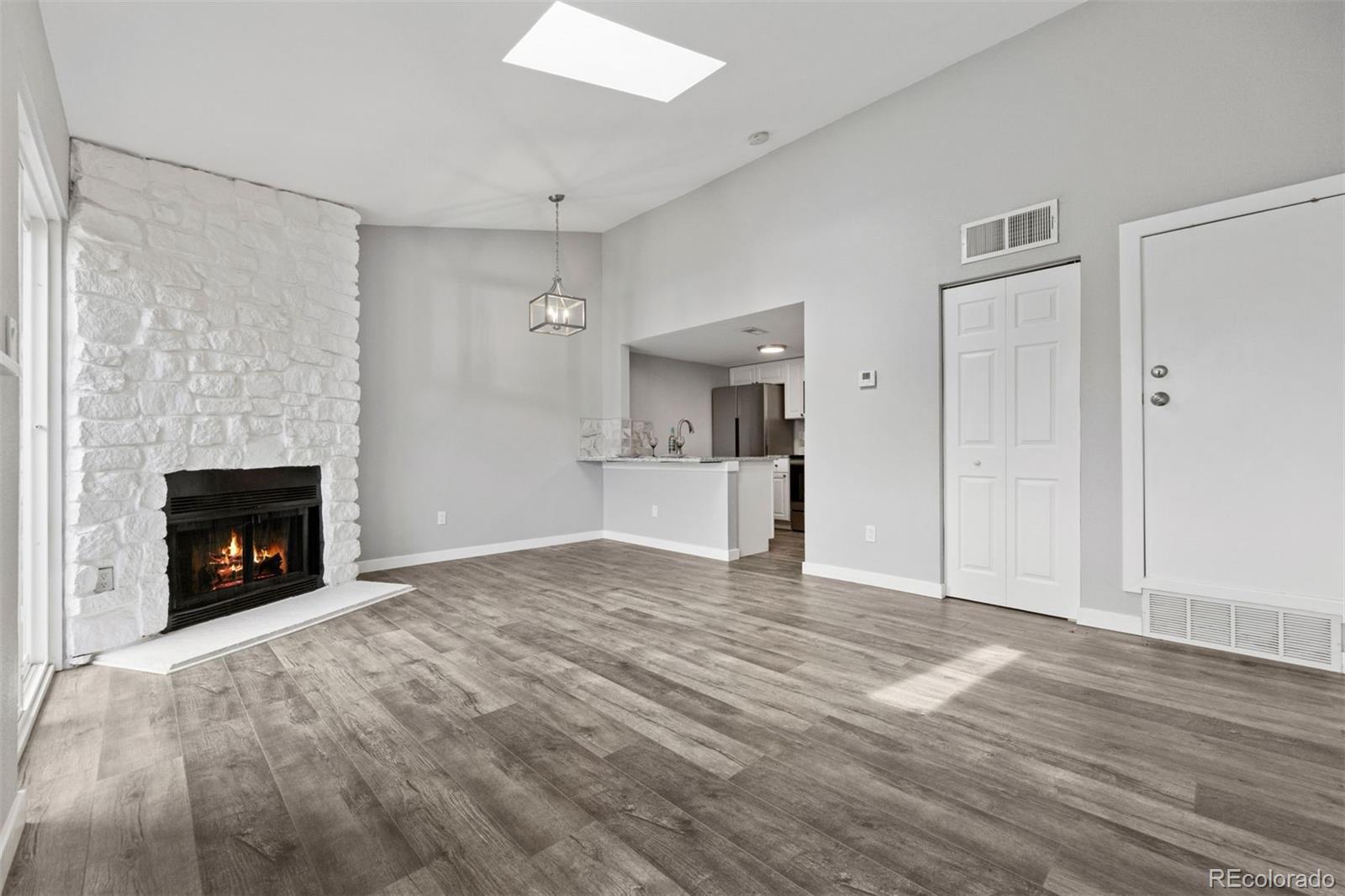 3100 South Federal Boulevard, Unit 331 Denver, CO 80236 - Photo 20 of 29 a view of empty room with a fireplace and wooden floor