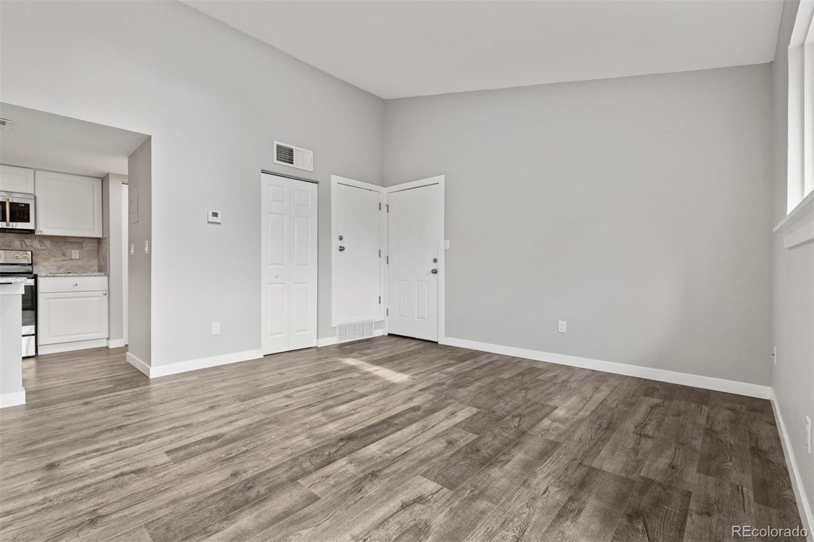3100 South Federal Boulevard, Unit 331 Denver, CO 80236 - Photo 21 of 29 a view of an empty room and wooden floor
