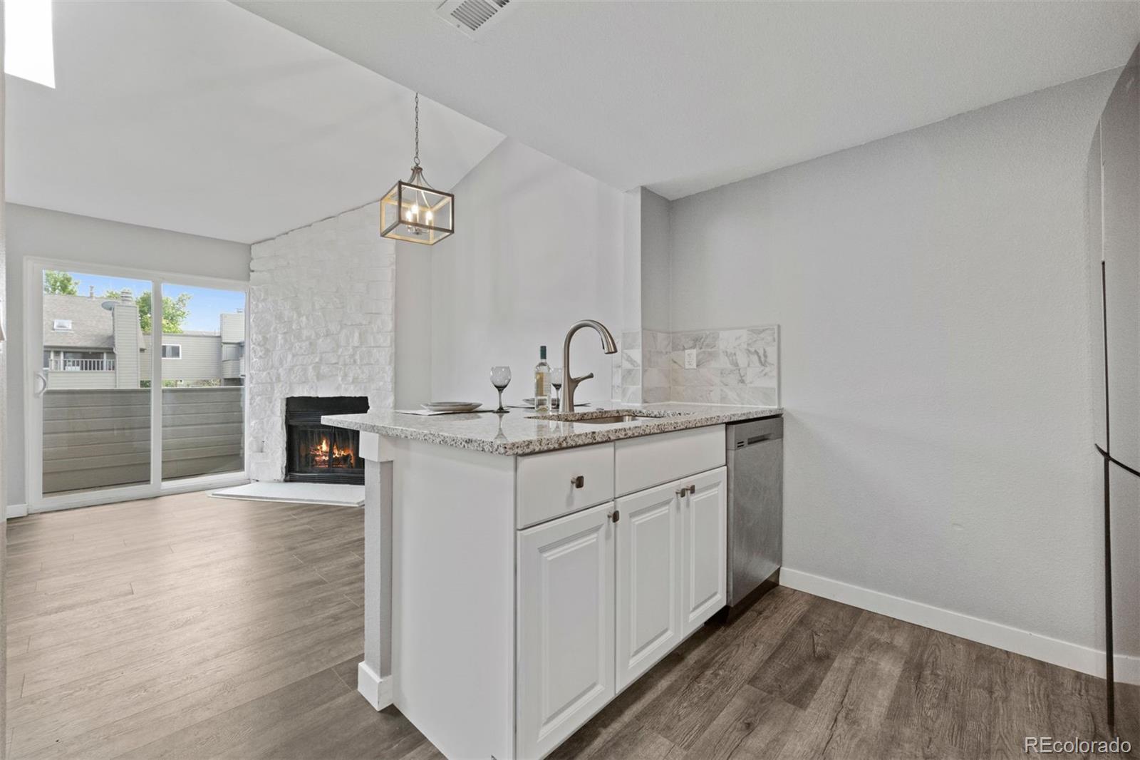 3100 South Federal Boulevard, Unit 331 Denver, CO 80236 - Photo 22 of 29 a spacious bathroom with a granite countertop sink and a mirror