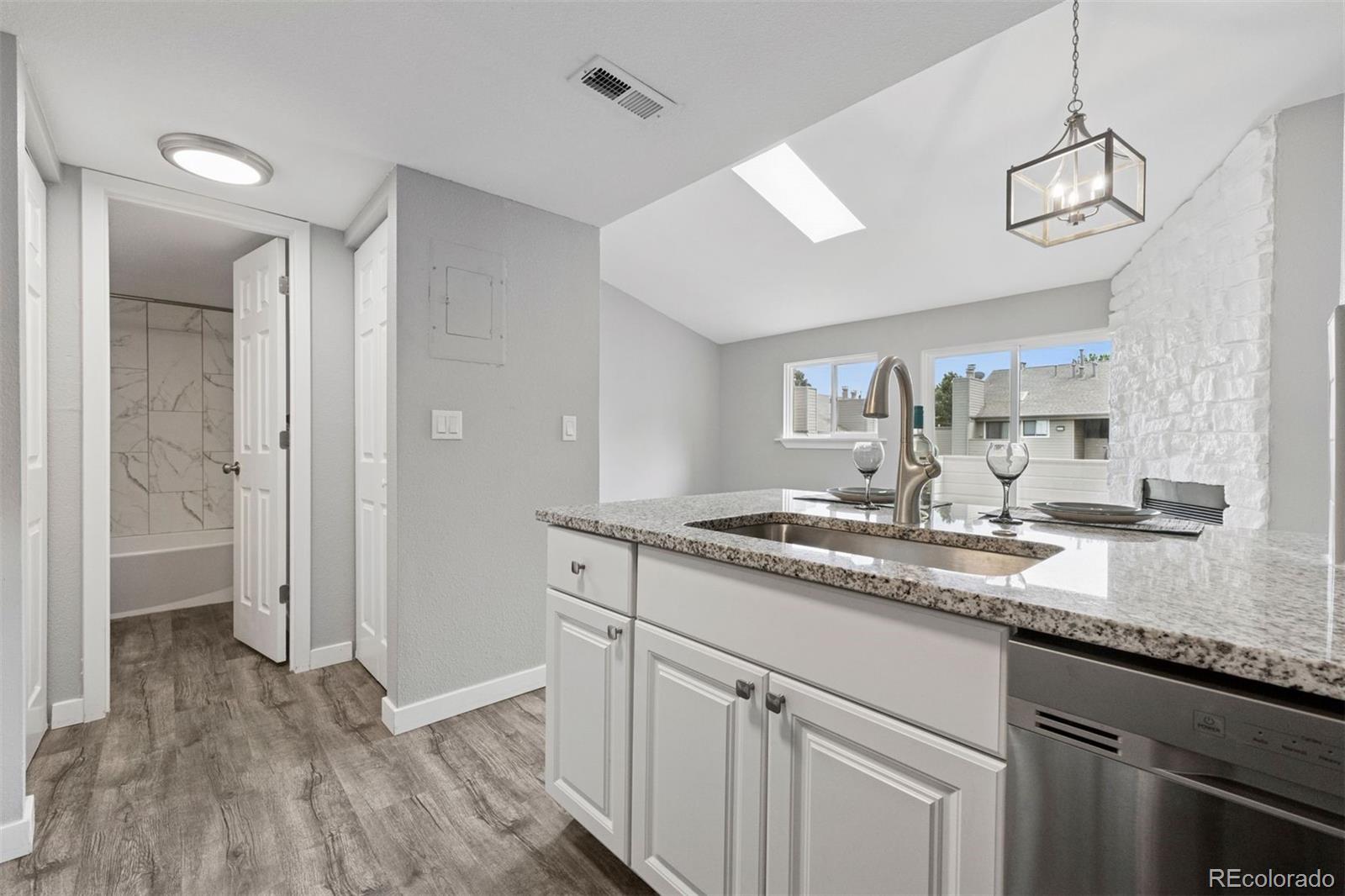 3100 South Federal Boulevard, Unit 331 Denver, CO 80236 - Photo 23 of 29 a kitchen with a sink and a refrigerator