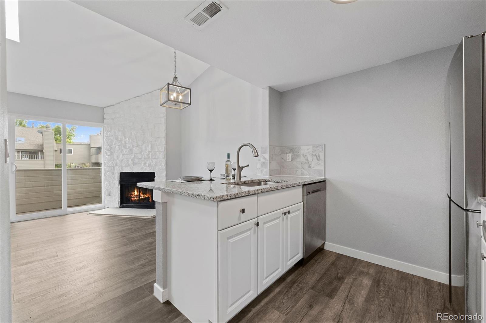 3100 South Federal Boulevard, Unit 331 Denver, CO 80236 - Photo 24 of 29 a spacious bathroom with a granite countertop sink a mirror and a shower