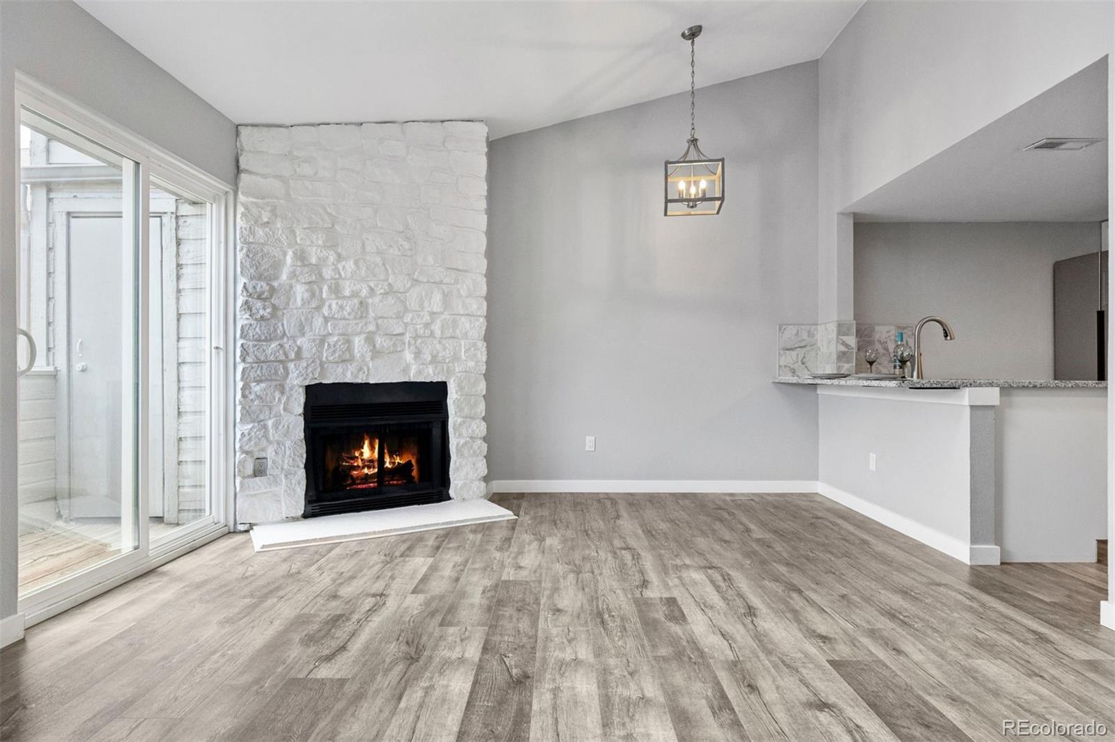 3100 South Federal Boulevard, Unit 331 Denver, CO 80236 - Photo 26 of 29 a view of an empty room with a fireplace and a window