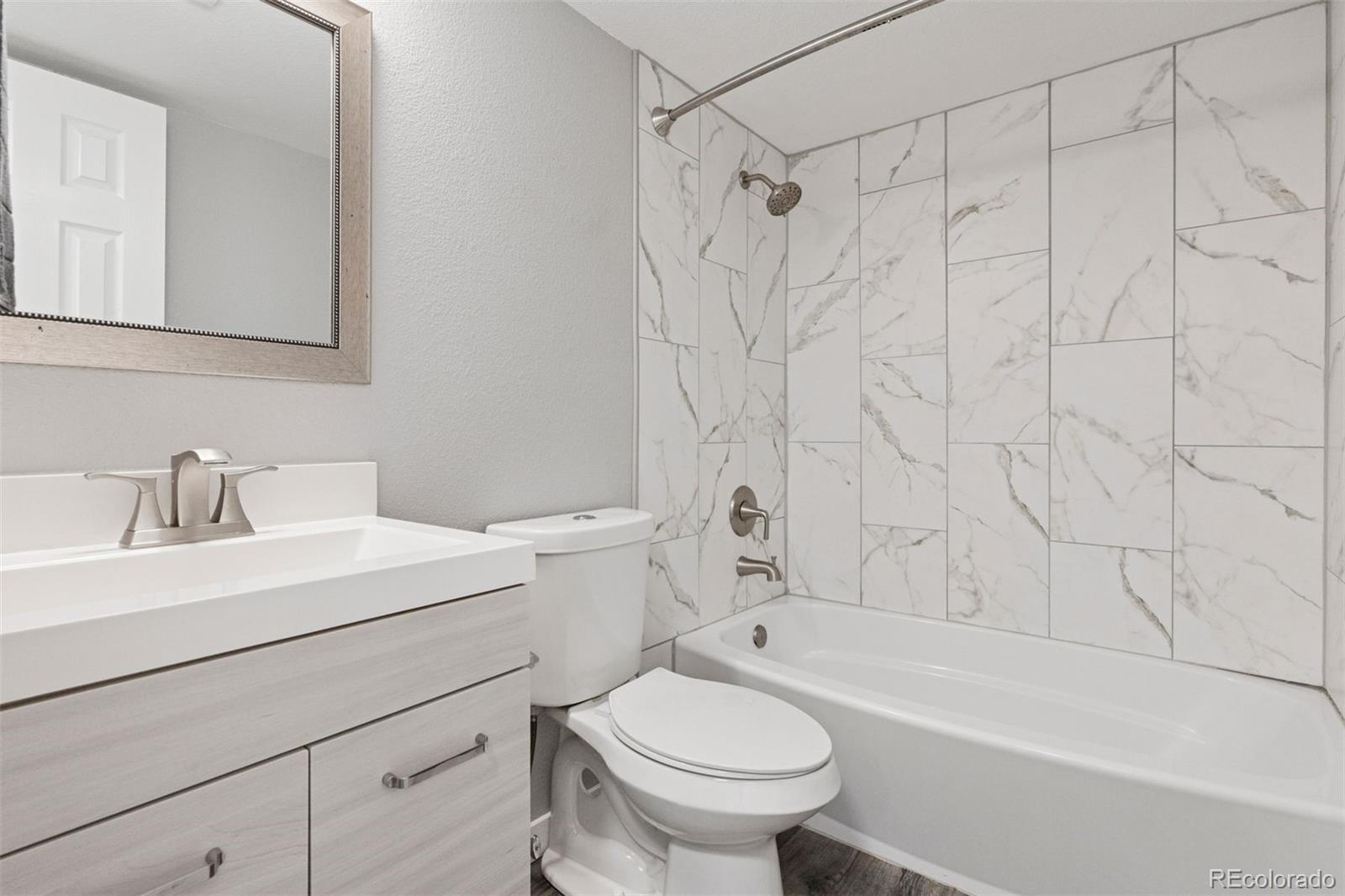 3100 South Federal Boulevard, Unit 331 Denver, CO 80236 - Photo 8 of 29 a bathroom with a sink toilet and shower