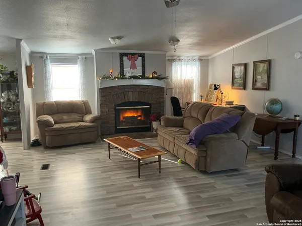 a living room with furniture and a fireplace