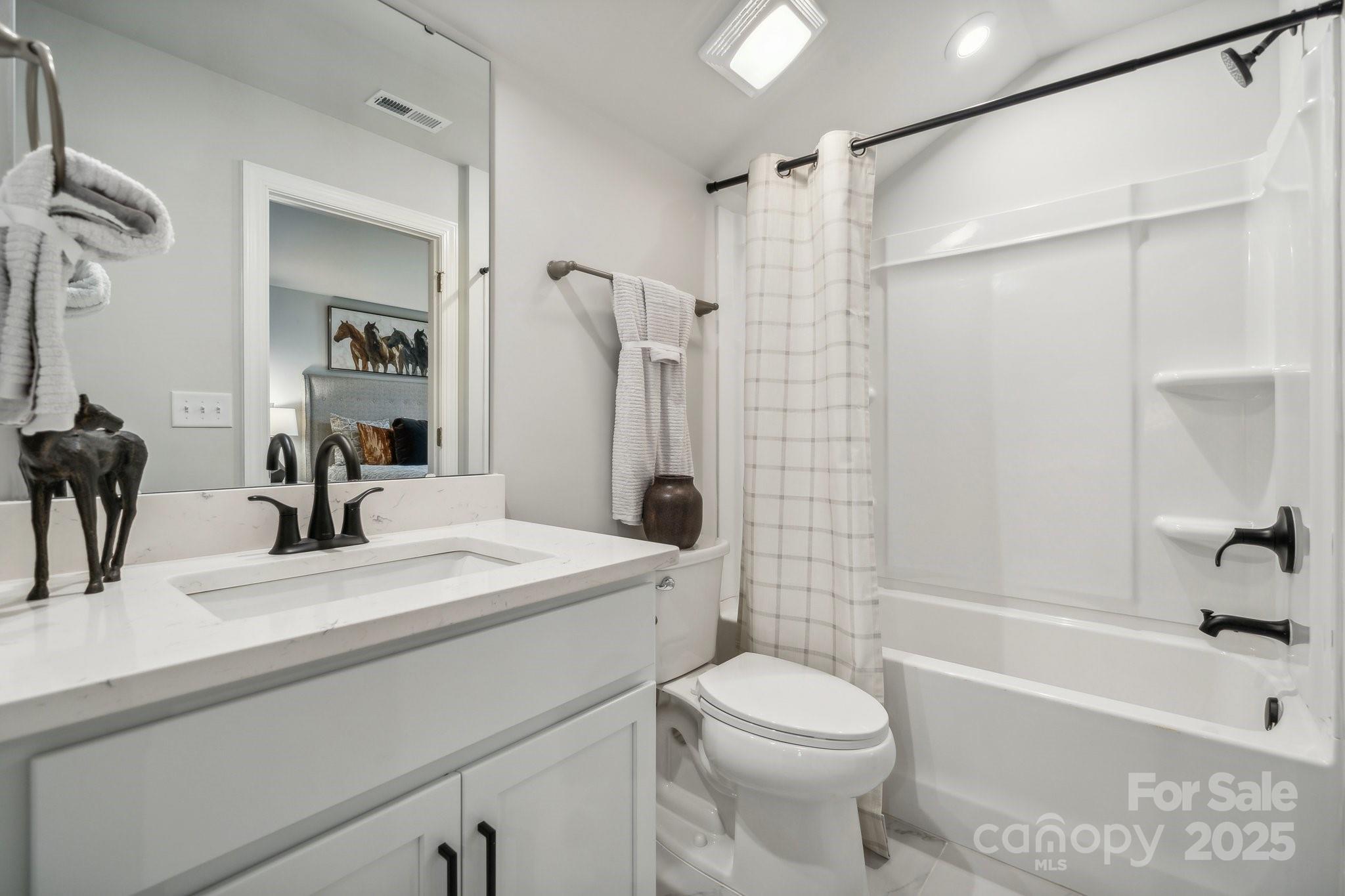 5119 Raging Crk Drive Indian Trail, NC 28079 - Photo 11 of 34 a bathroom with a sink a toilet and a bathtub