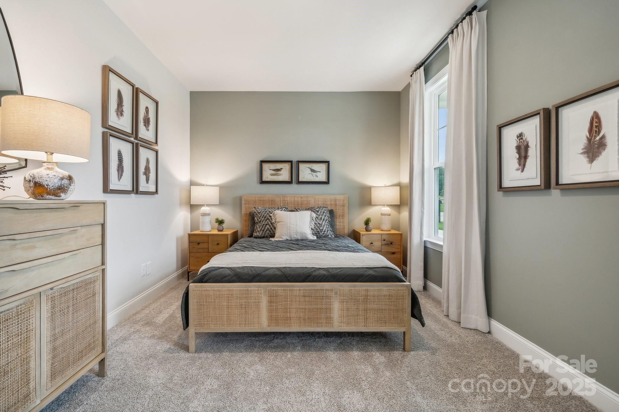 5119 Raging Crk Drive Indian Trail, NC 28079 - Photo 12 of 34 a spacious bedroom with a bed and painting on the wall