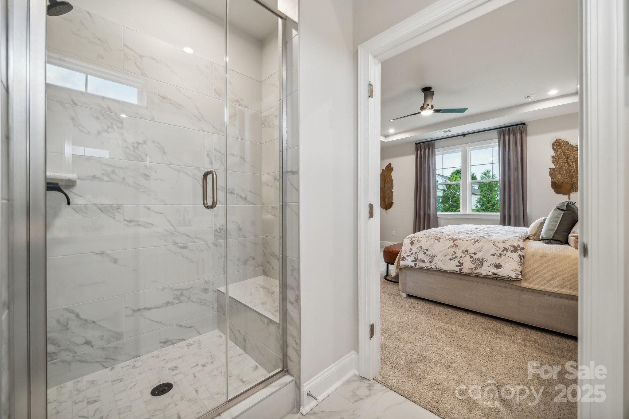 5119 Raging Crk Drive Indian Trail, NC 28079 - Photo 5 of 34 a bedroom with a bed and a glass door shower