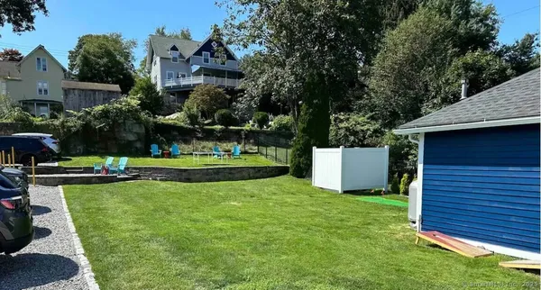 a view of a house with swimming pool and sitting area