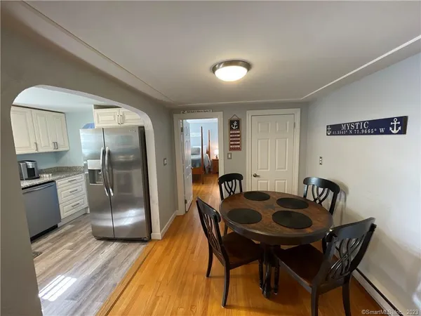 a kitchen with a table chairs and refrigerator