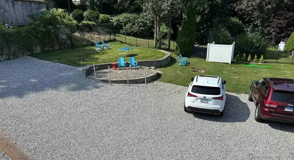 a white house with a yard and plants