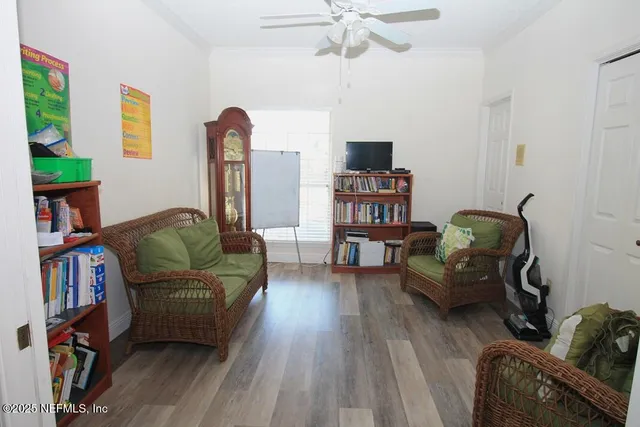 a bedroom with two beds chair and a desk