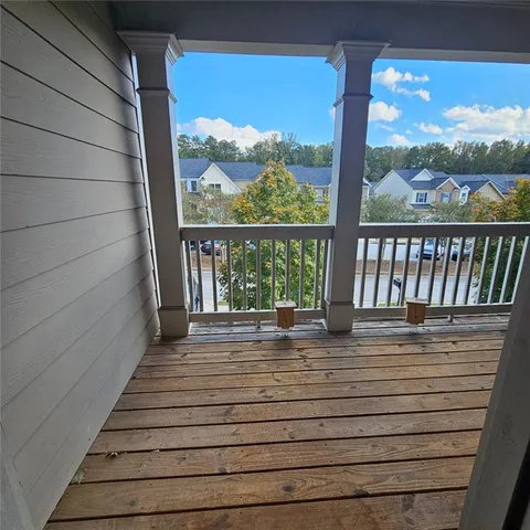 a view of a balcony with wooden floor