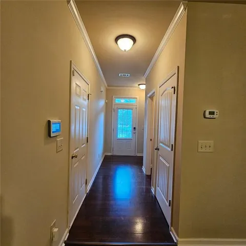 a view of a hallway with wooden floor