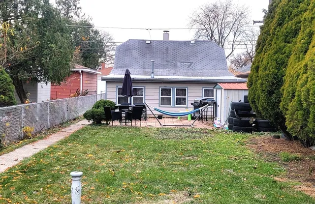 a house view with a sitting space and garden