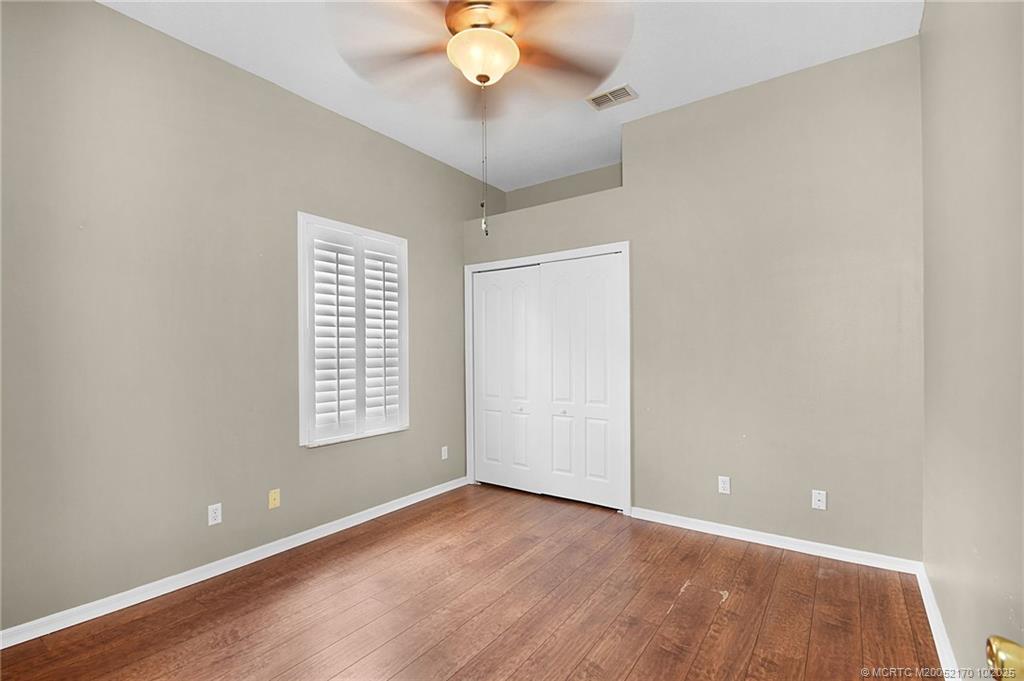 439 Northwest Sunflower Place Stuart, FL 34994 - Photo 14 of 68 wooden floor in an empty room with a window