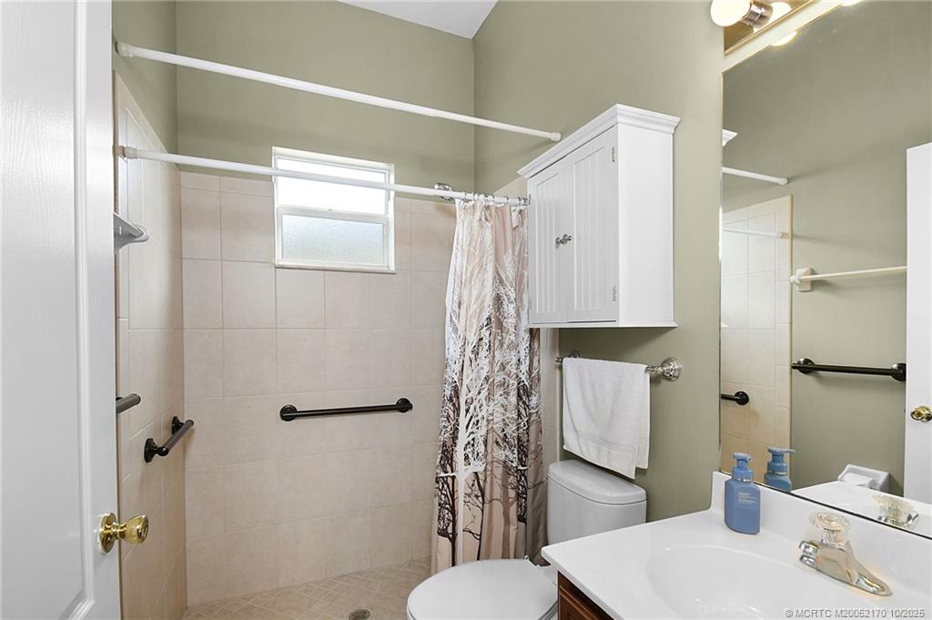 439 Northwest Sunflower Place Stuart, FL 34994 - Photo 15 of 68 a bathroom with a sink toilet and shower