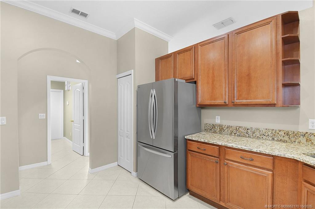 439 Northwest Sunflower Place Stuart, FL 34994 - Photo 17 of 68 a kitchen with stainless steel appliances granite countertop a refrigerator and a sink
