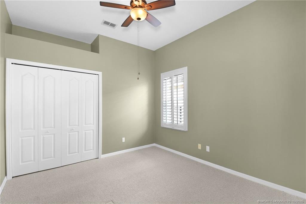 439 Northwest Sunflower Place Stuart, FL 34994 - Photo 21 of 68 an empty room with a window and a fan