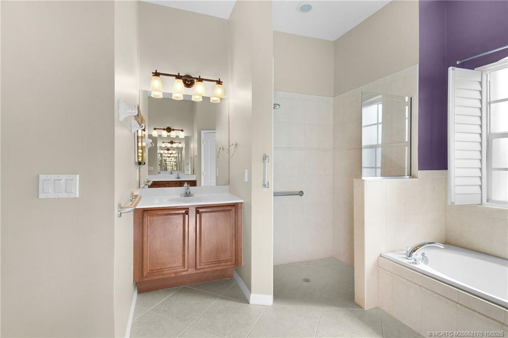 439 Northwest Sunflower Place Stuart, FL 34994 - Photo 27 of 68 a bathroom with a granite countertop sink and a mirror