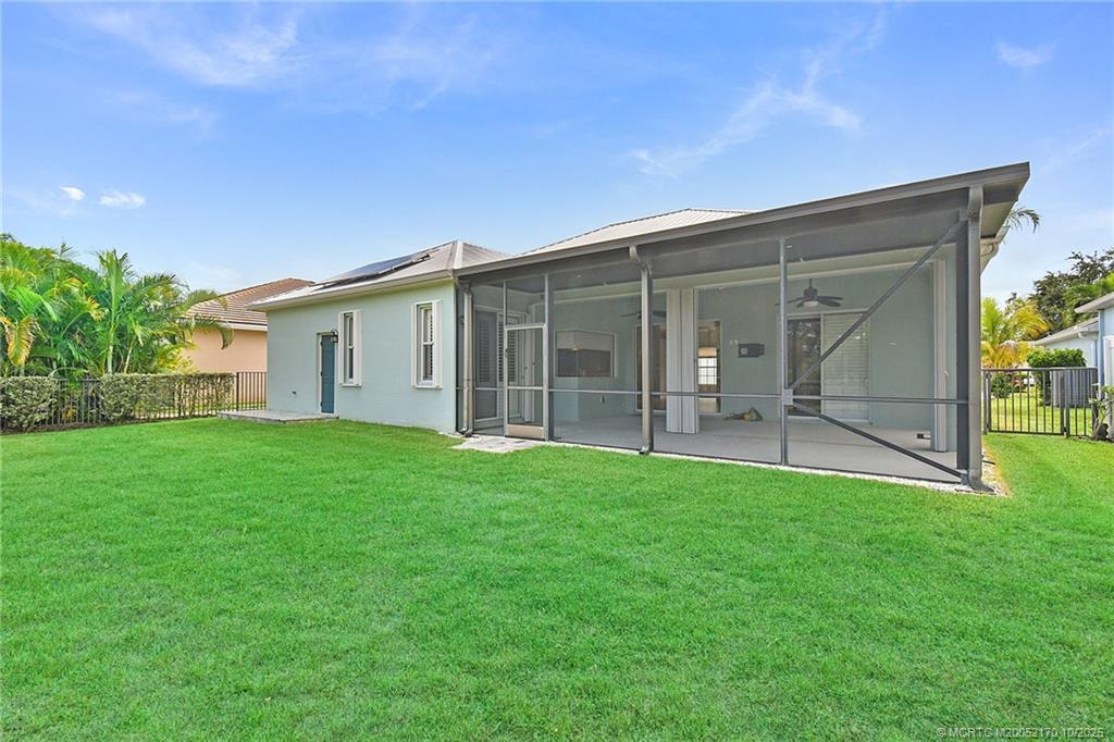 439 Northwest Sunflower Place Stuart, FL 34994 - Photo 33 of 68 a view of a backyard with a garden and plants