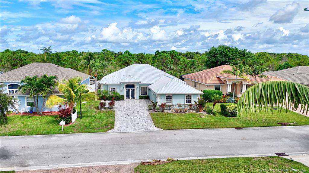 439 Northwest Sunflower Place Stuart, FL 34994 - Photo 41 of 68 a front view of house with yard and green space