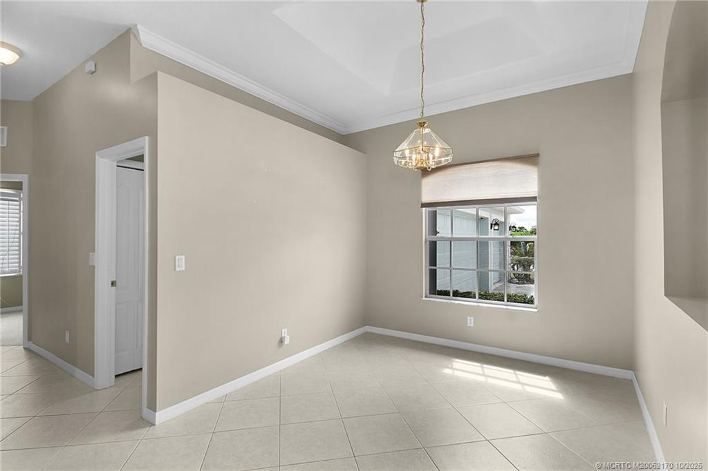 439 Northwest Sunflower Place Stuart, FL 34994 - Photo 5 of 68 a view of a room with window and chandelier fan