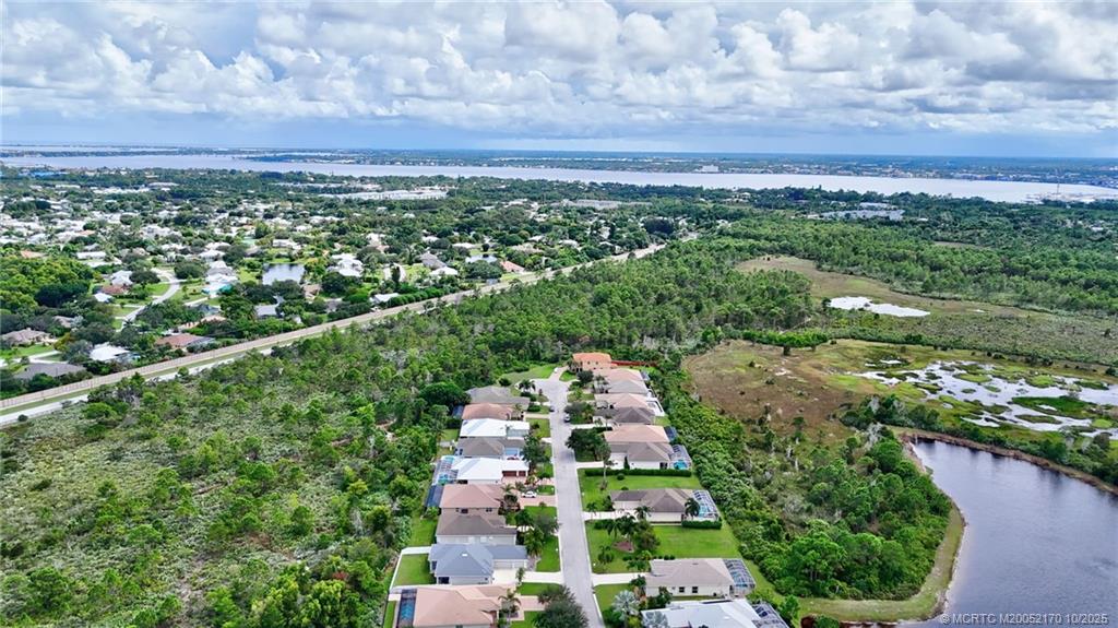 439 Northwest Sunflower Place Stuart, FL 34994 - Photo 52 of 68 a view of a city with lush green forest
