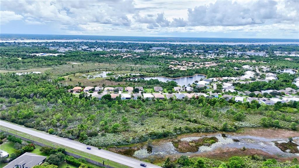439 Northwest Sunflower Place Stuart, FL 34994 - Photo 55 of 68 a view of a city with lush green forest