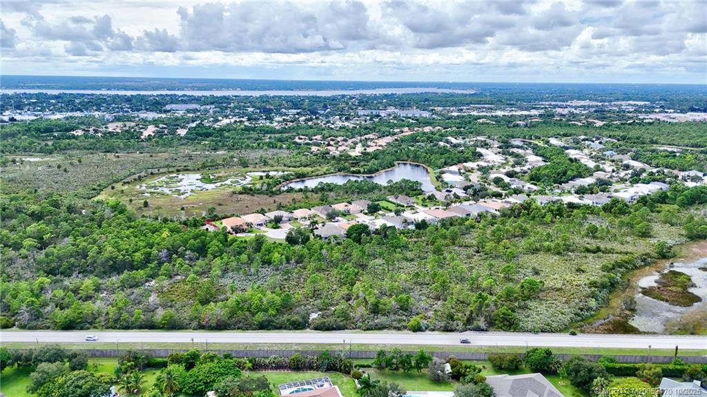 439 Northwest Sunflower Place Stuart, FL 34994 - Photo 56 of 68 a view of a city with lush green forest