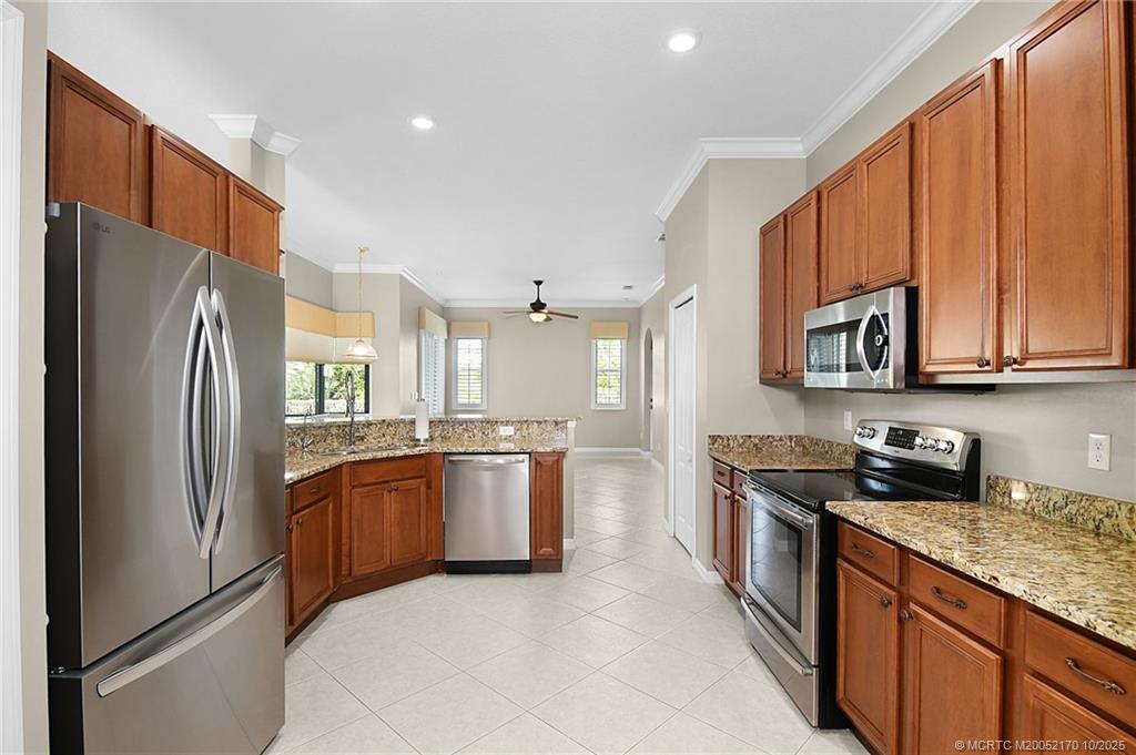 439 Northwest Sunflower Place Stuart, FL 34994 - Photo 6 of 68 a kitchen with stainless steel appliances granite countertop a refrigerator stove and sink