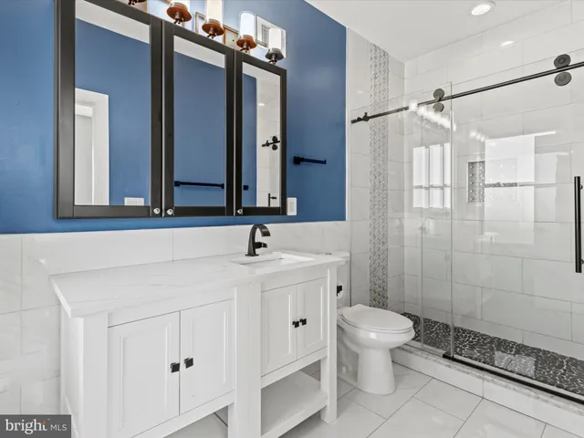 a bathroom with a toilet sink and shower