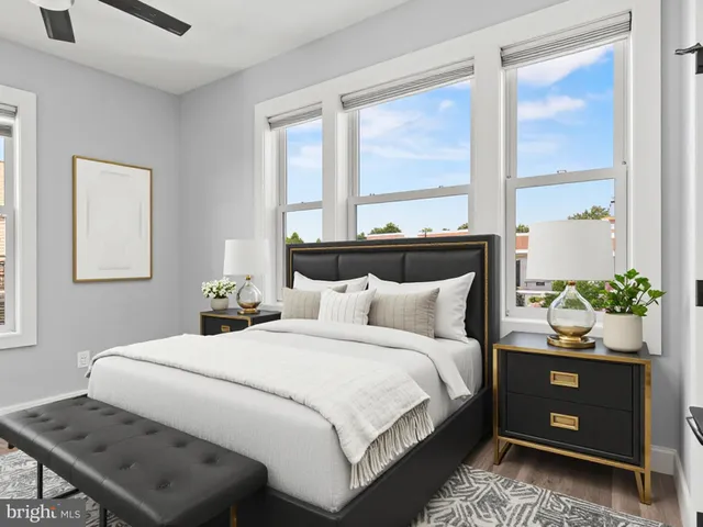 a bedroom with a bed and windows