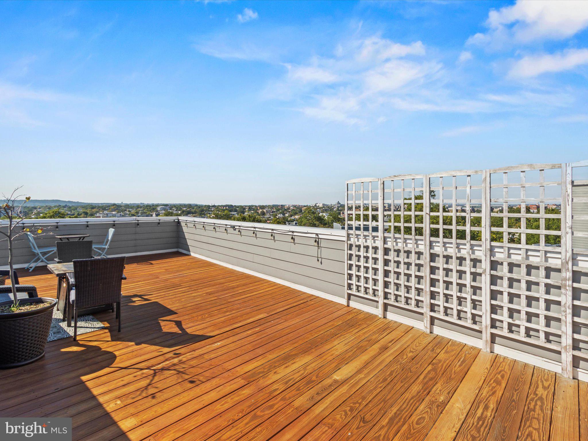 1267 Penn Street Northeast, Unit B Washington, DC 20002 - Photo 20 of 20 a view of roof deck with wooden floor and city view