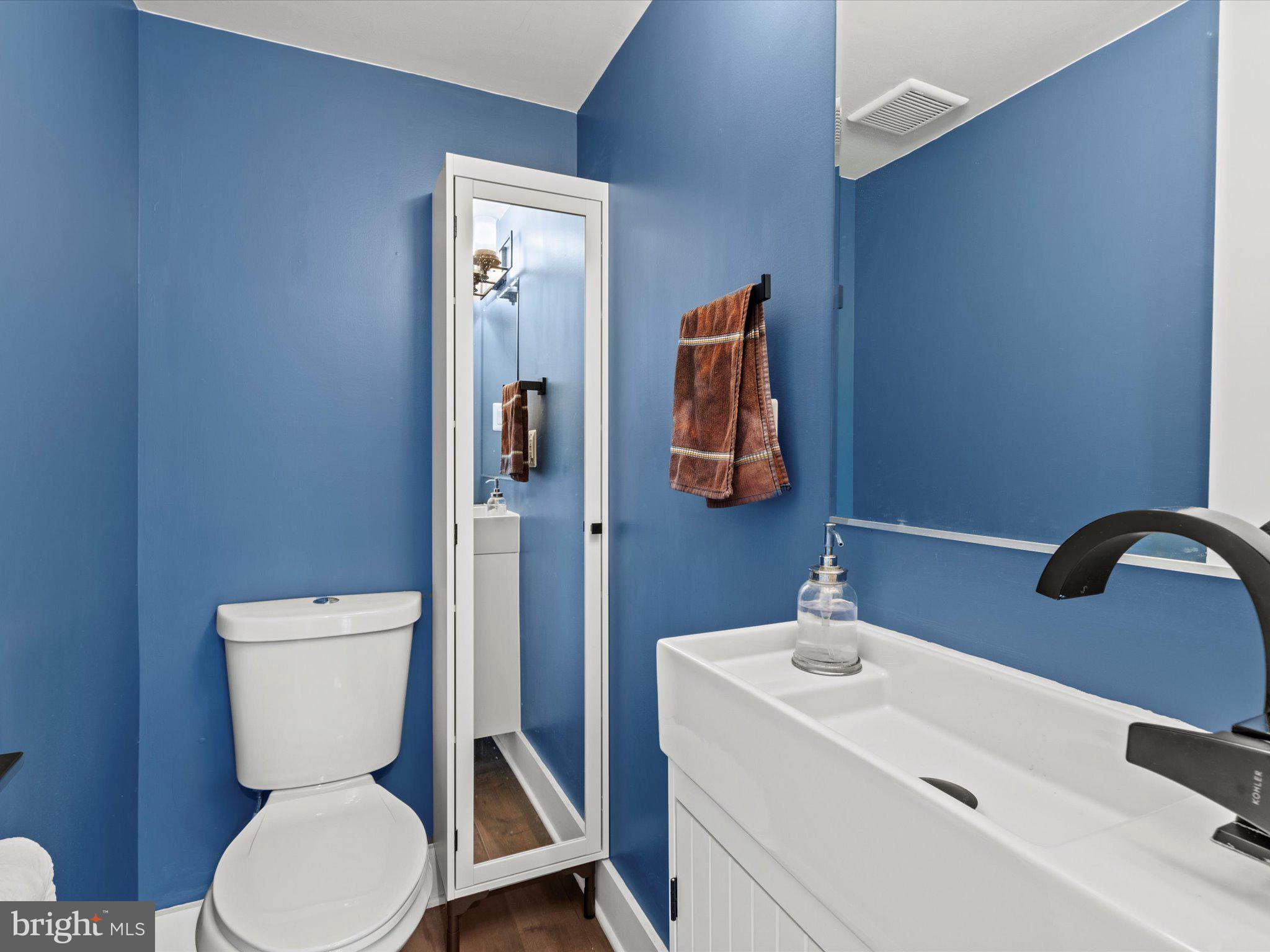 1267 Penn Street Northeast, Unit B Washington, DC 20002 - Photo 7 of 20 a bathroom with a toilet sink and mirror