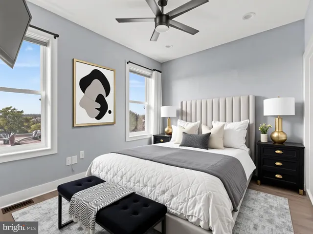 a bedroom with a bed and a painting on the wall