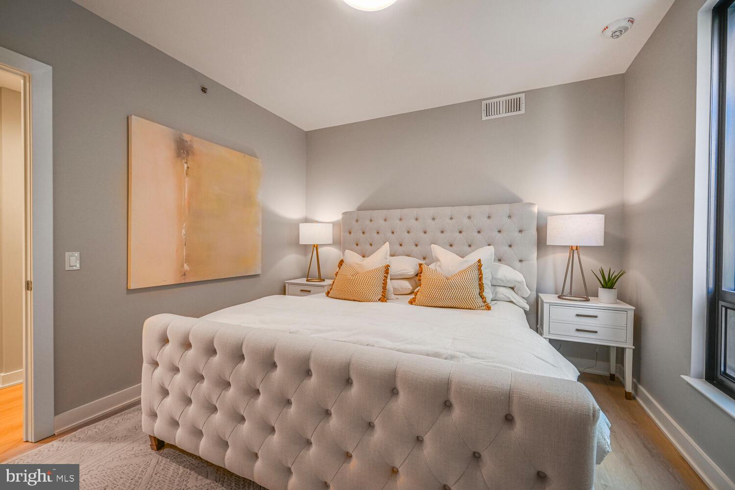 950 3rd Street Northwest, Unit 901 Washington, DC 20001 - Photo 26 of 30 a bedroom with a bed and a night stand