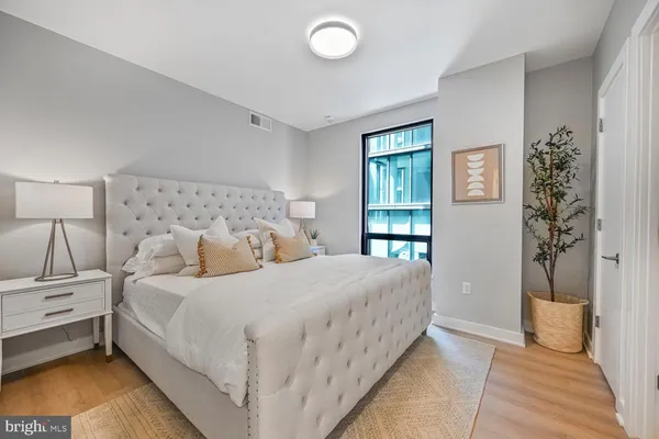 a bedroom with a bed and lamp