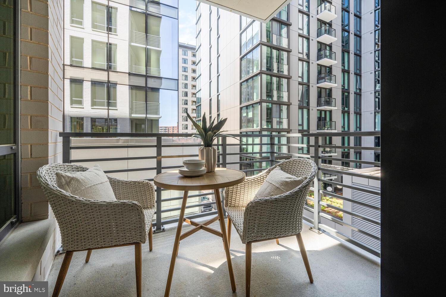 950 3rd Street Northwest, Unit 901 Washington, DC 20001 - Photo 30 of 30 a view of a building from a chairs and table in the balcony