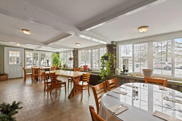 a very nice looking dining room with furniture and a large window