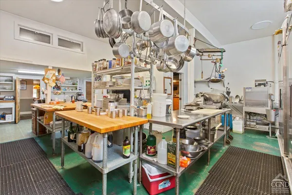 a utility room with lots of wooden furniture and washing machine