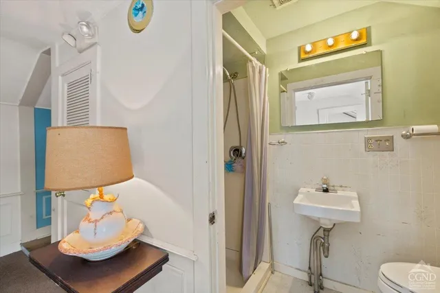 a bathroom with a sink toilet and mirror